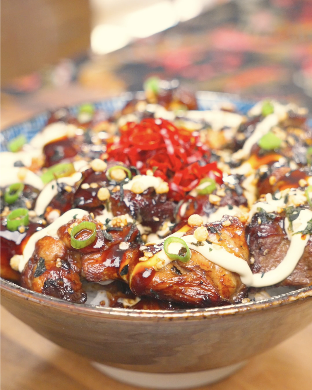 Finished Garlic Teriyaki Chicken Recipe over rice with kewpie mayo, soy glaze, furikake, scallions, and pickled ginger.