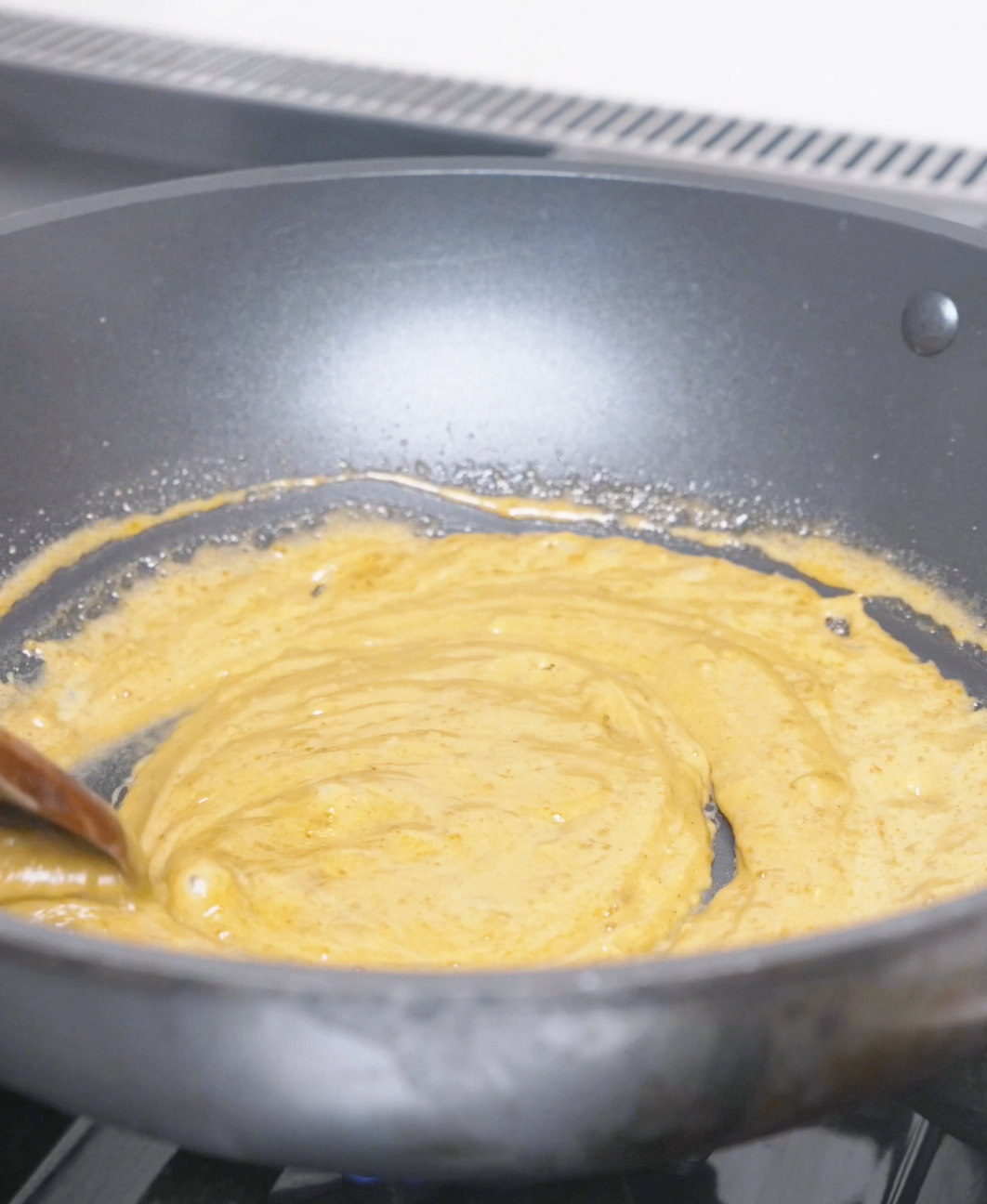 The roux fully dissolved into a smooth golden cream sauce in the pan for Creamy Curry Noodles Recipe.