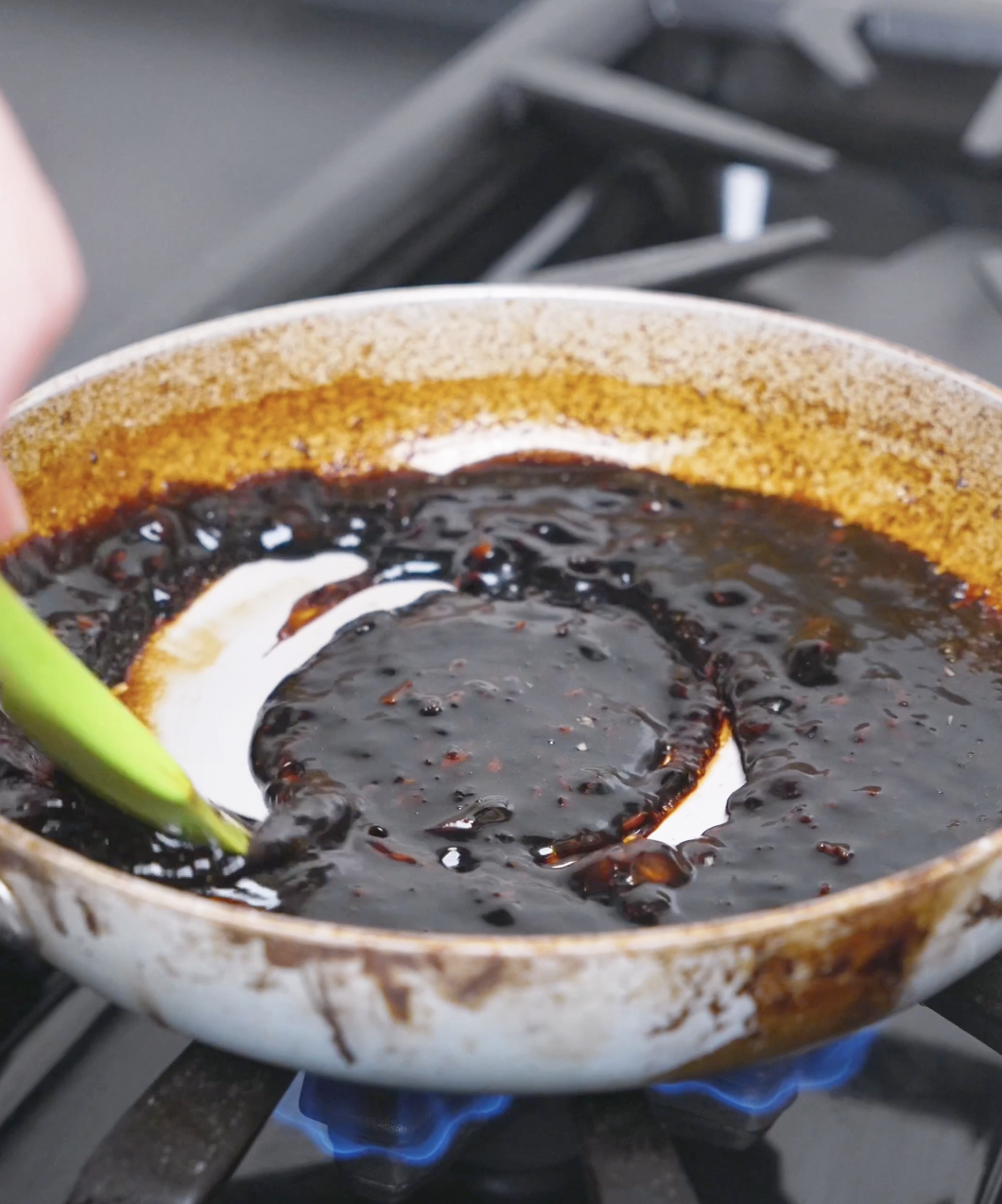 The teriyaki sauce being stirred until thick and glossy enough to coat the pan for Teriyaki Meatballs Recipe.