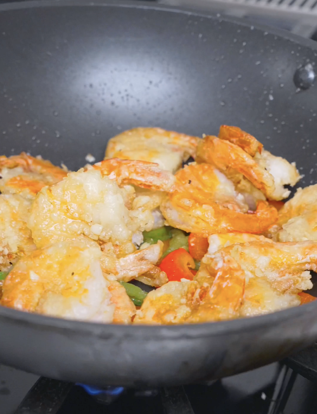 Shrimp and peppers tossed together until evenly coated in seasoning for Salt and Pepper Shrimp Recipe.