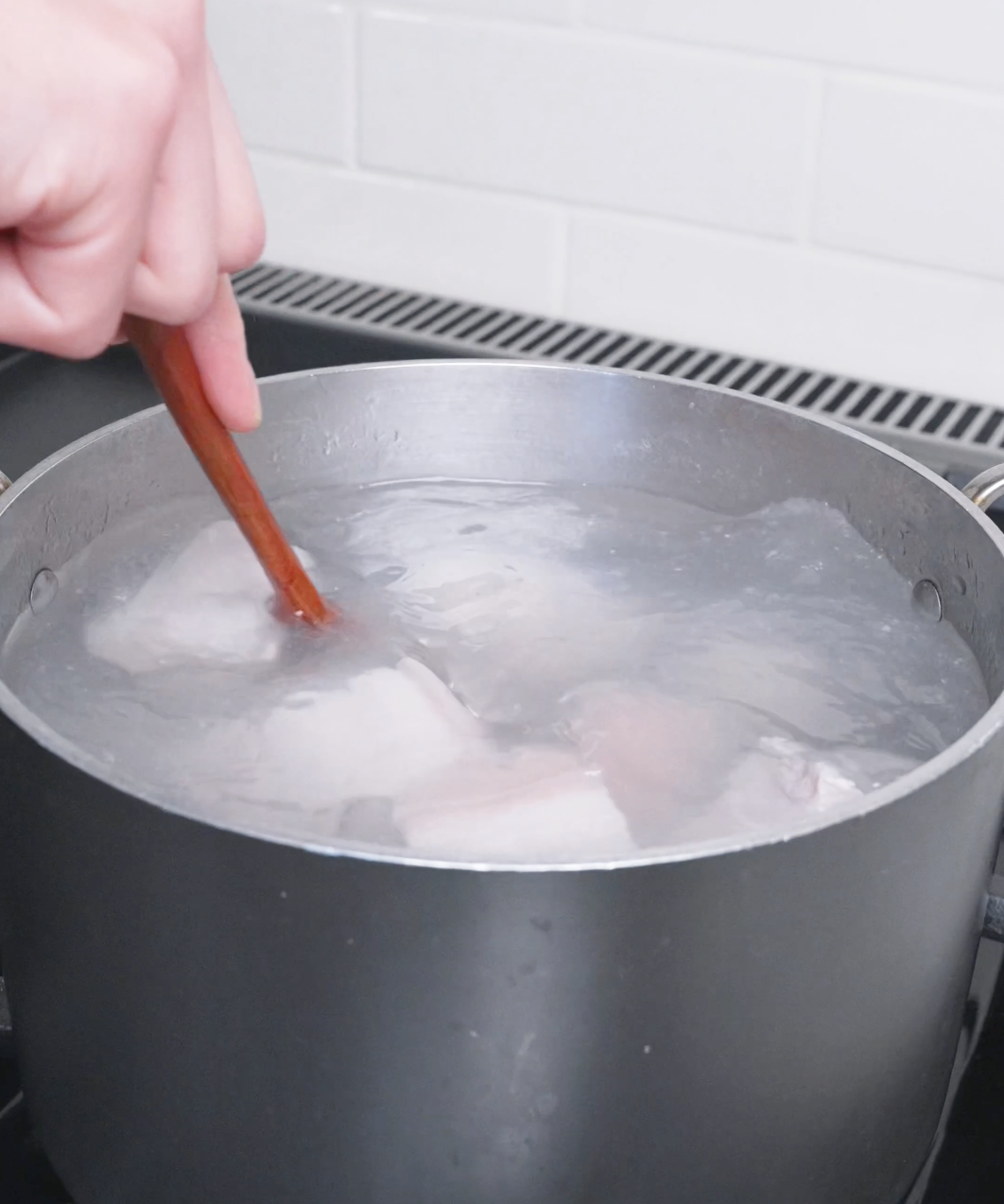 Pork belly chunks blanching in boiling water to remove impurities for Red Braised Pork Belly Recipe.