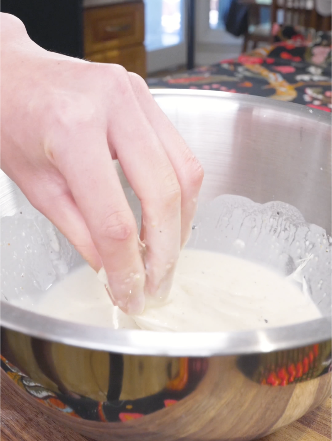 Sliced enoki being turned in the batter until every strand is coated for Crispy Fried Enoki Mushrooms Recipe.