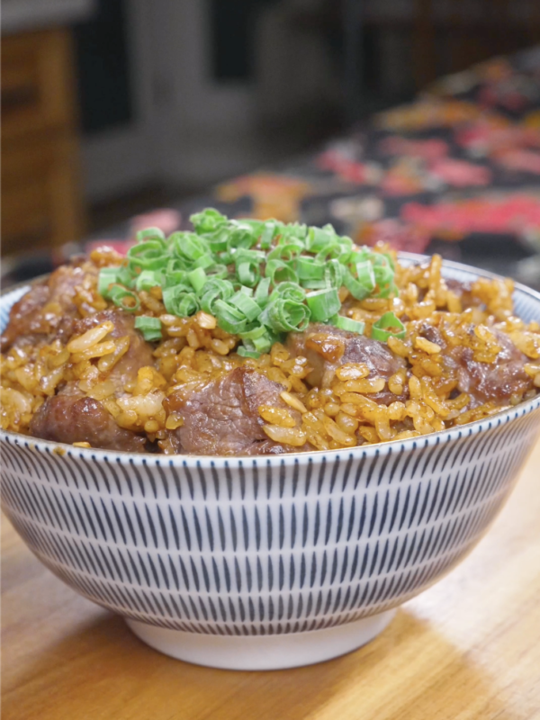 Finished Garlic Butter Steak Fried Rice Recipe in a patterned bowl with steak cubes and scallions.