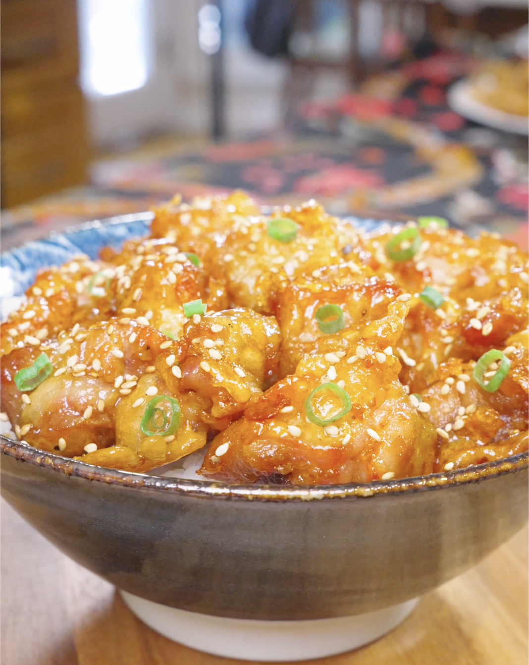 Finished Sweet Honey Fried Chicken Recipe over rice with sesame seeds and sliced scallions.