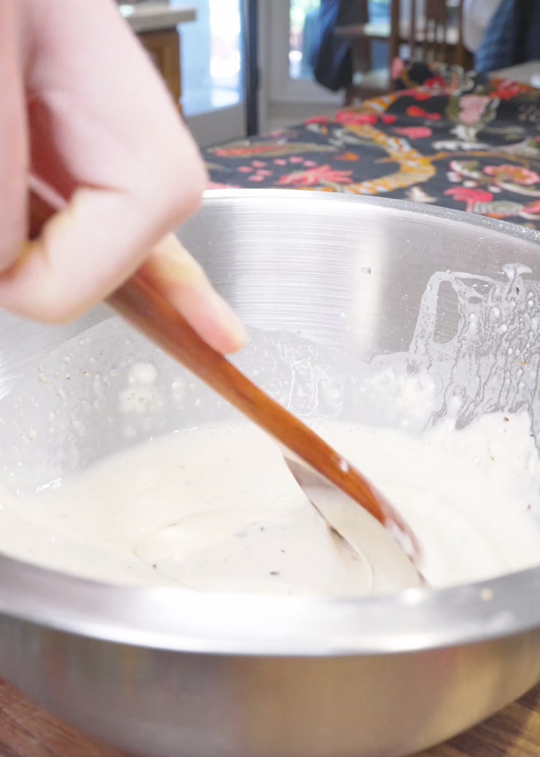 Flour, cornstarch, and seasoning being stirred with water into a batter for Sweet Honey Fried Chicken Recipe.