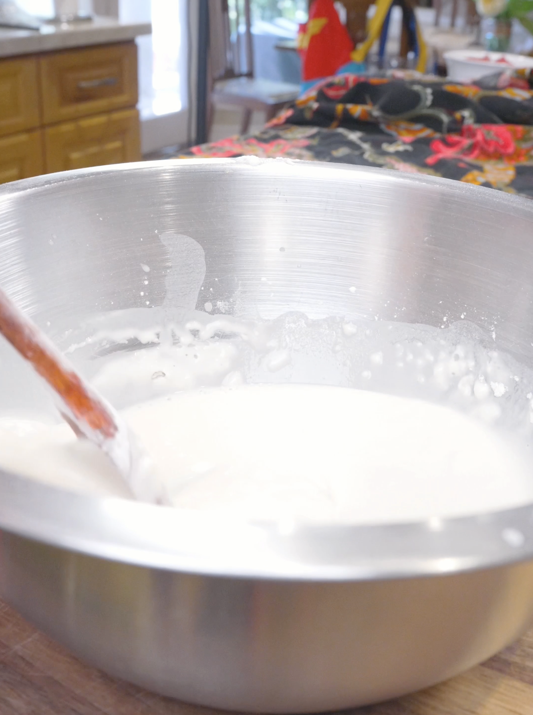 Cornstarch, water, and salt being stirred into a smooth white batter for Orange Beef Recipe.