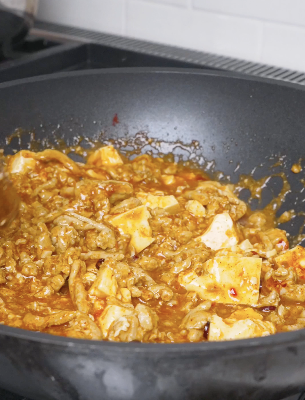 The red sauce thickened and clinging to the tofu and pork for Mapo Tofu Recipe.