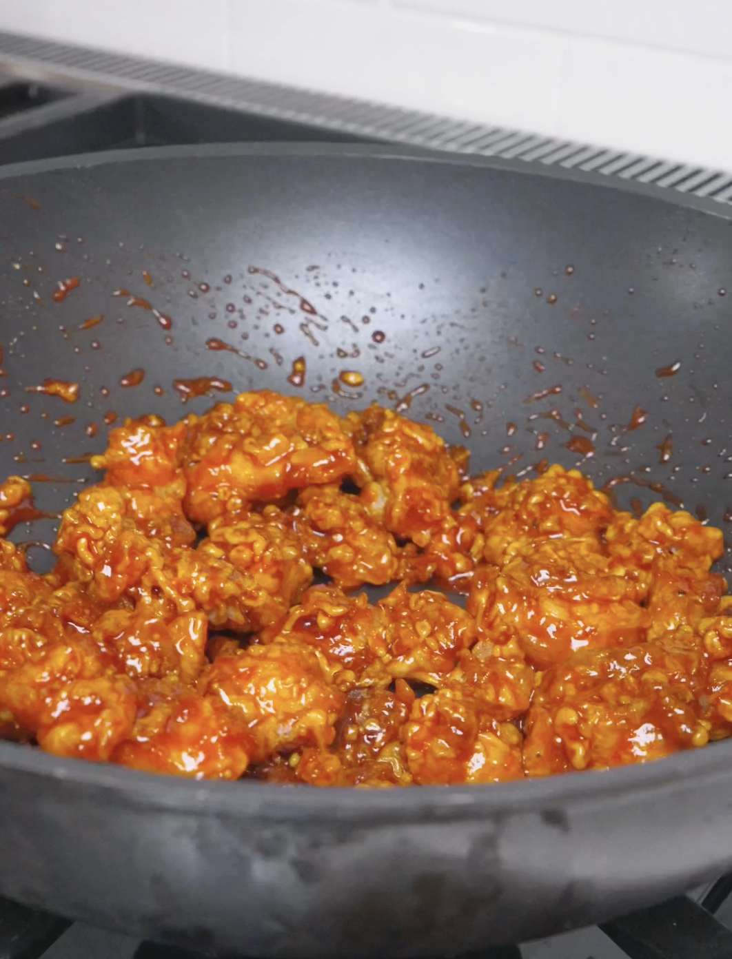 Chicken tossed until every piece is coated in the sticky red glaze for Korean Popcorn Chicken Recipe.